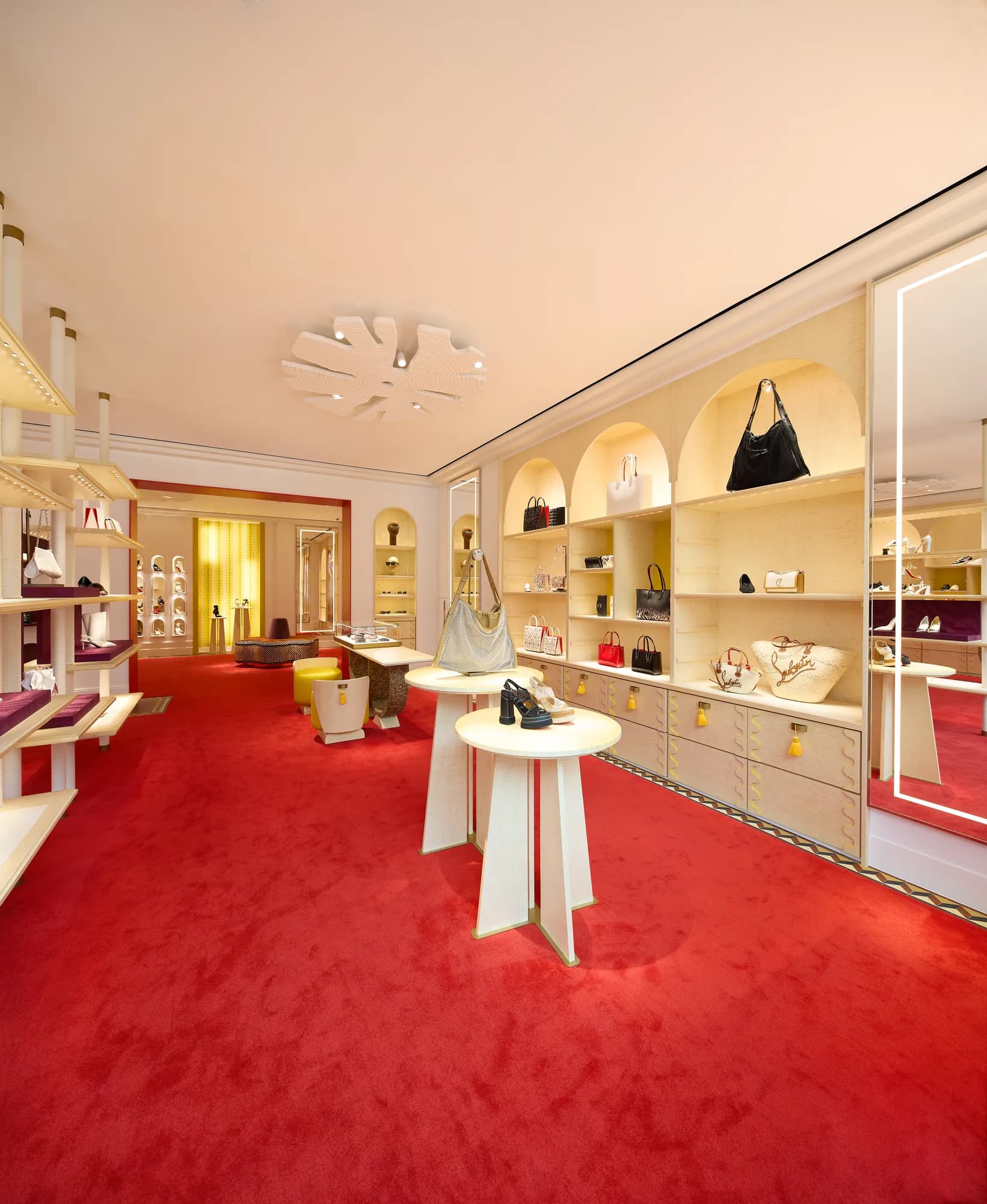 Long room with arched shelving and handbags in the Christian Louboutin boutique
