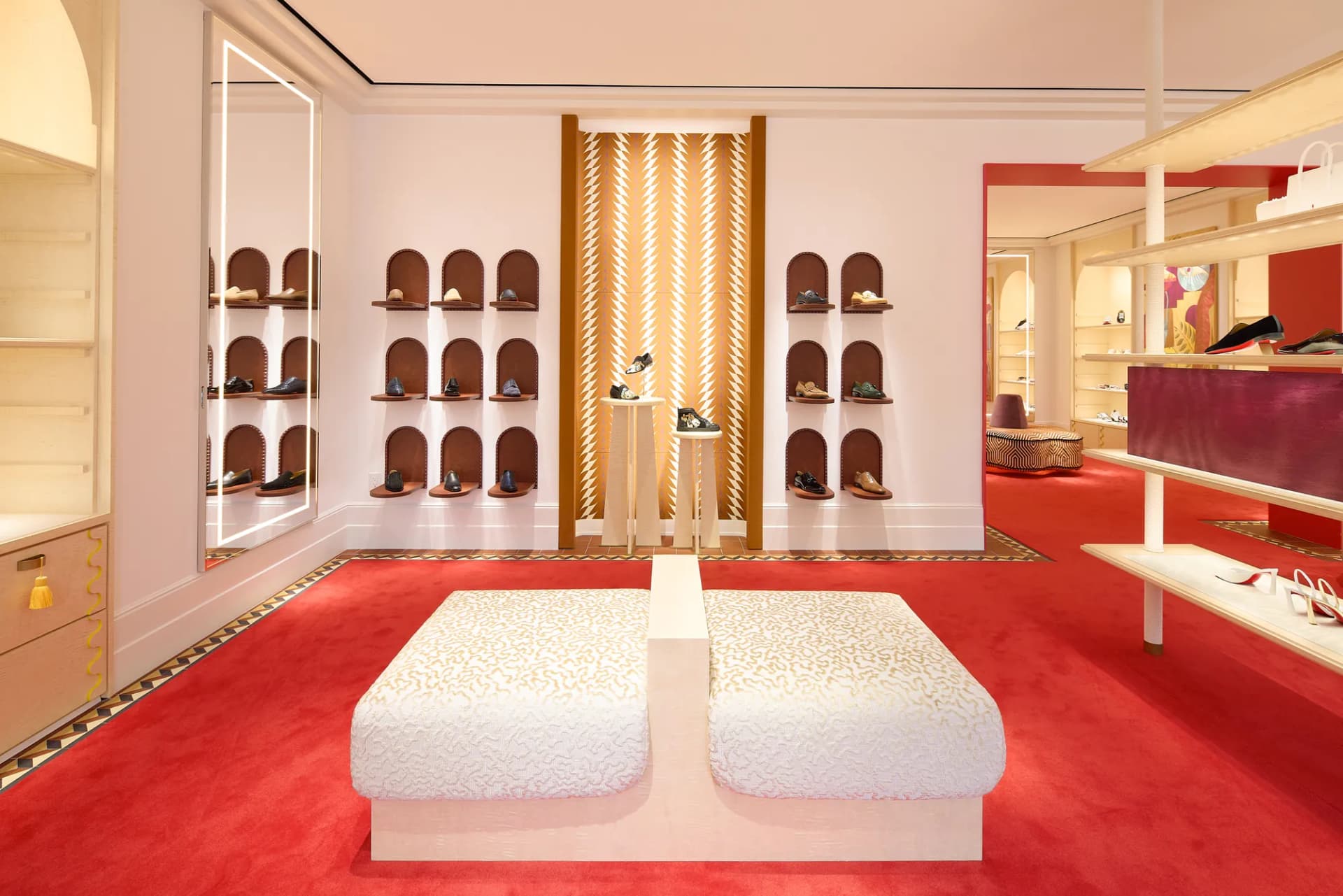 White bench and arched shoe displays in the boutique