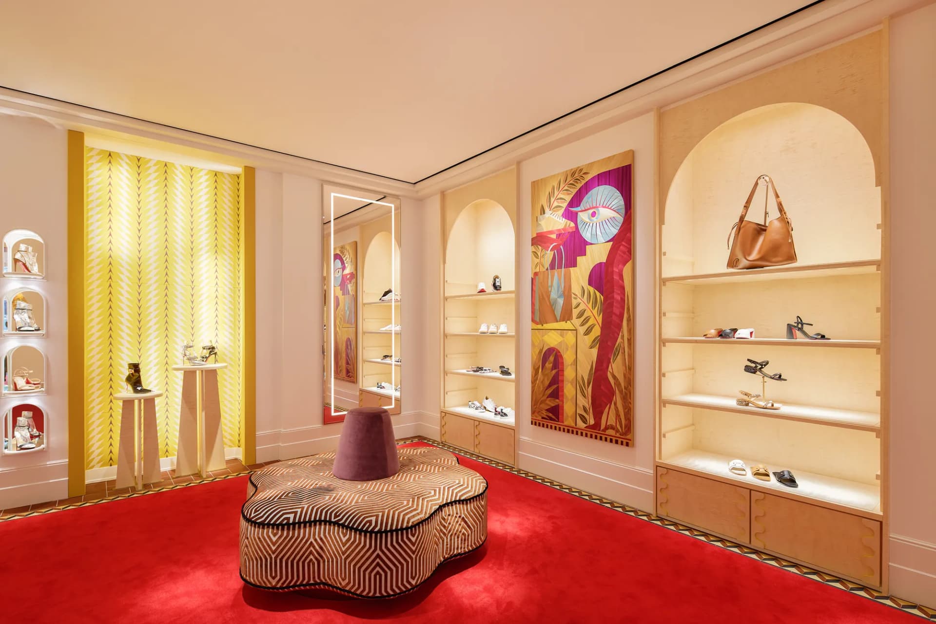 Patterned ottoman, artwork and arched shoe shelves in the boutique