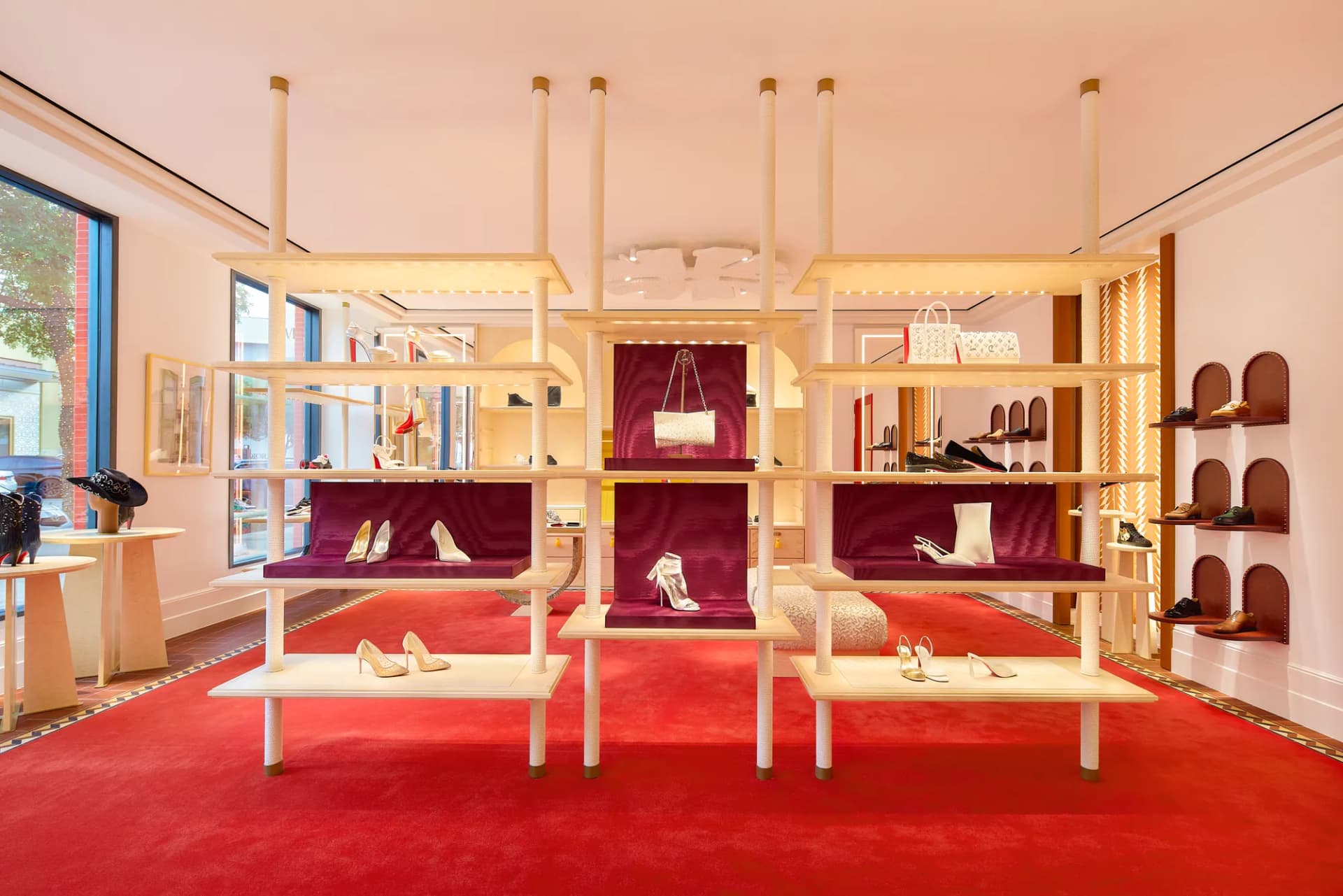 Center display of shoes and handbags on the red carpet of the Christian Louboutin boutique