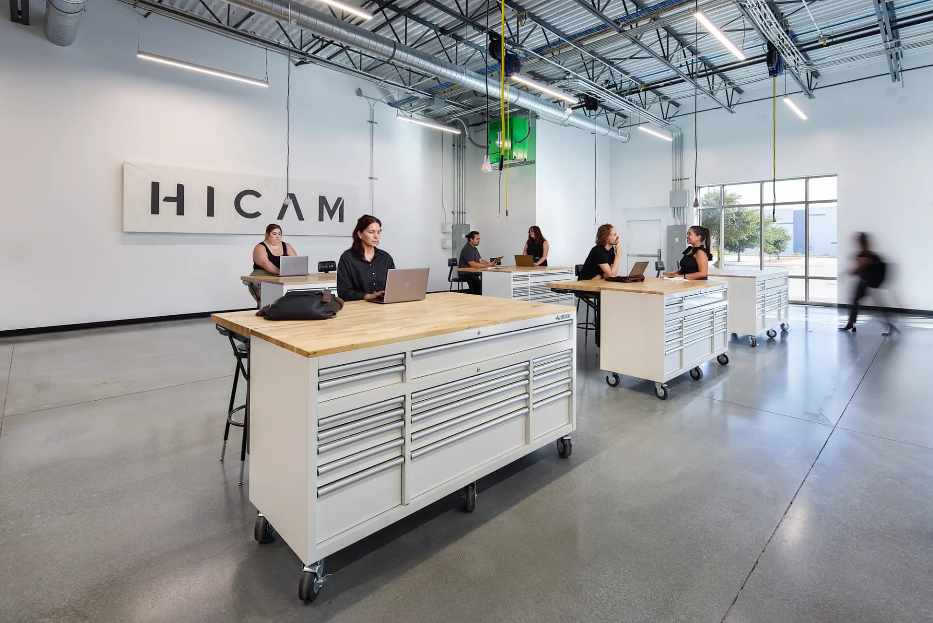 HICAM reception with the logo wall and open workspace