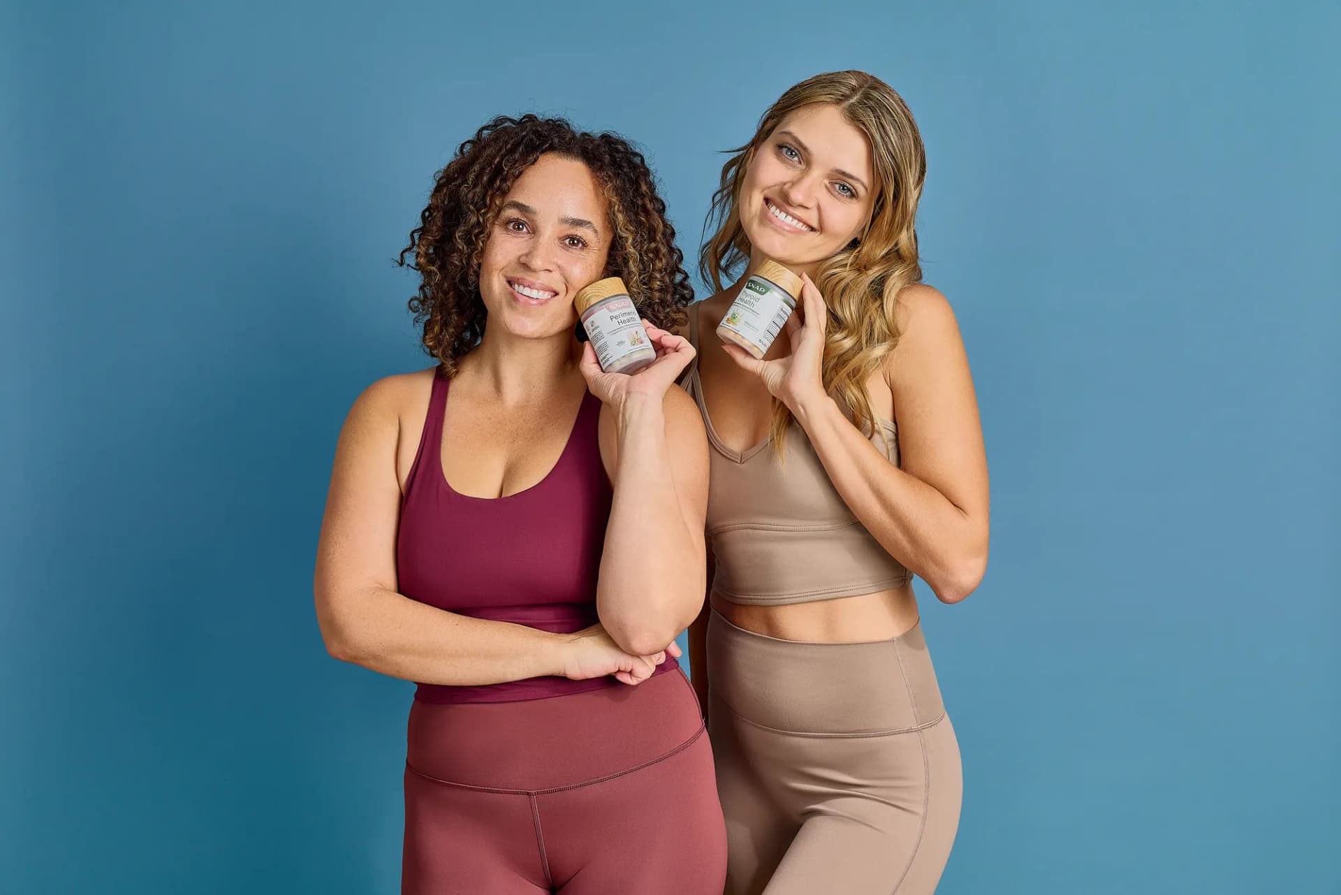 Two models in neutral athleisure posing with SNAP Supplements