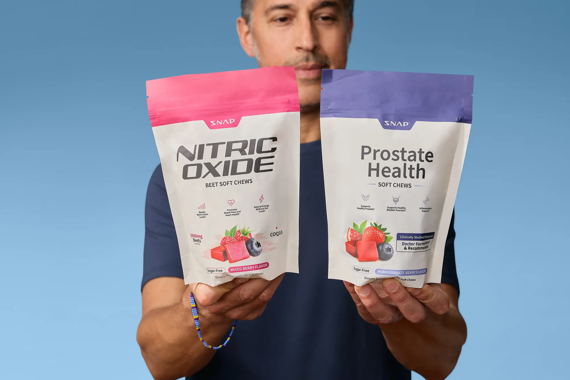 Close-up of two SNAP Supplements pouches held toward the camera