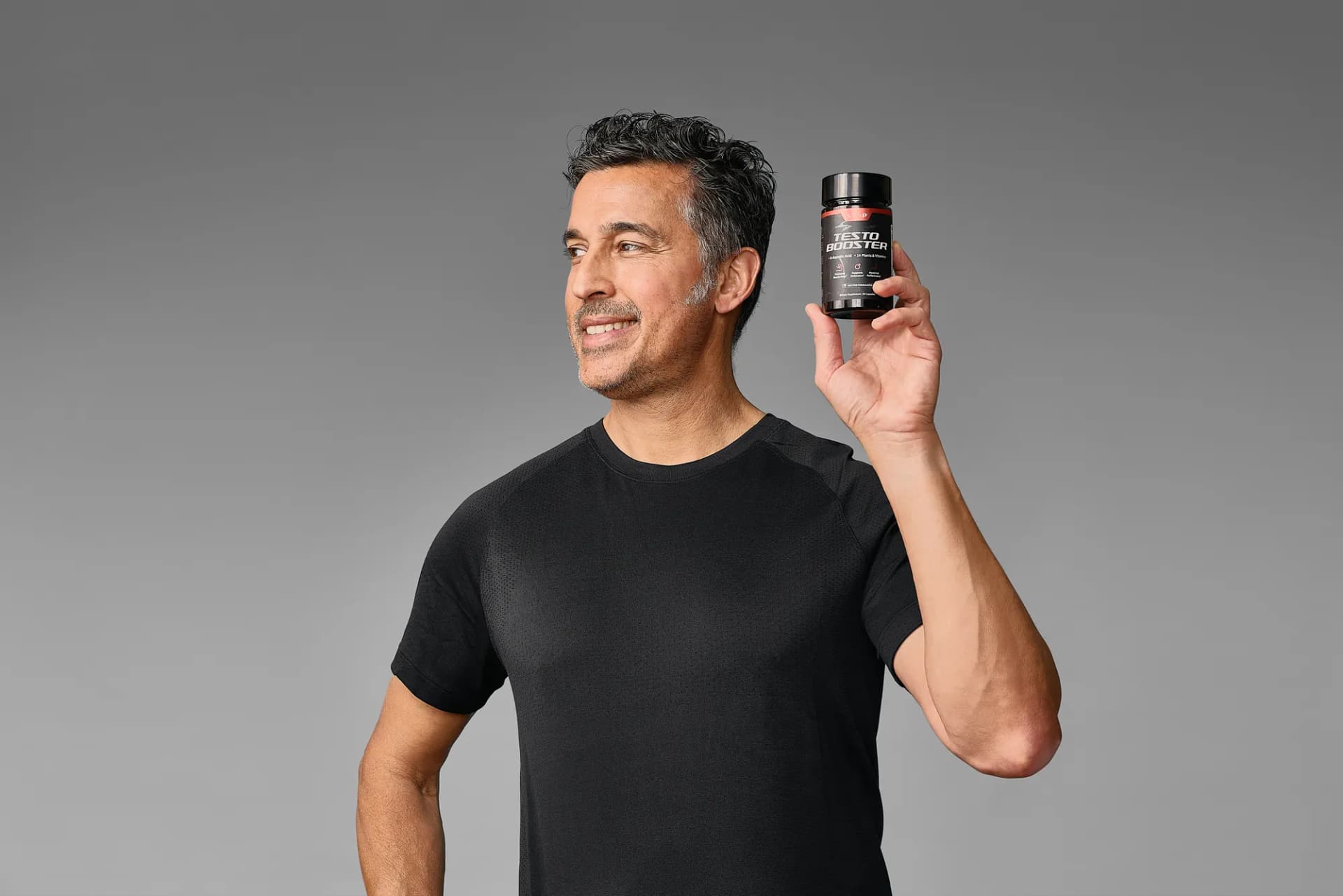 Model raising a SNAP Supplements bottle on a gray backdrop