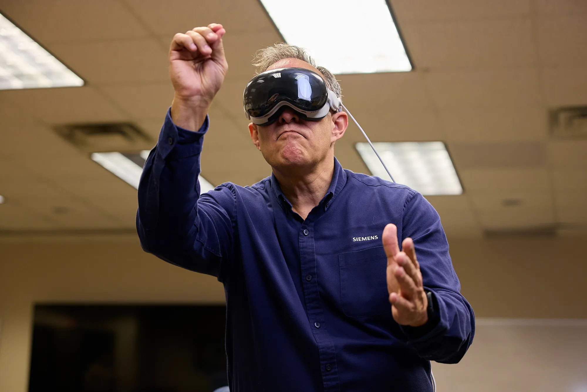 Man gesturing while using a mixed-reality headset