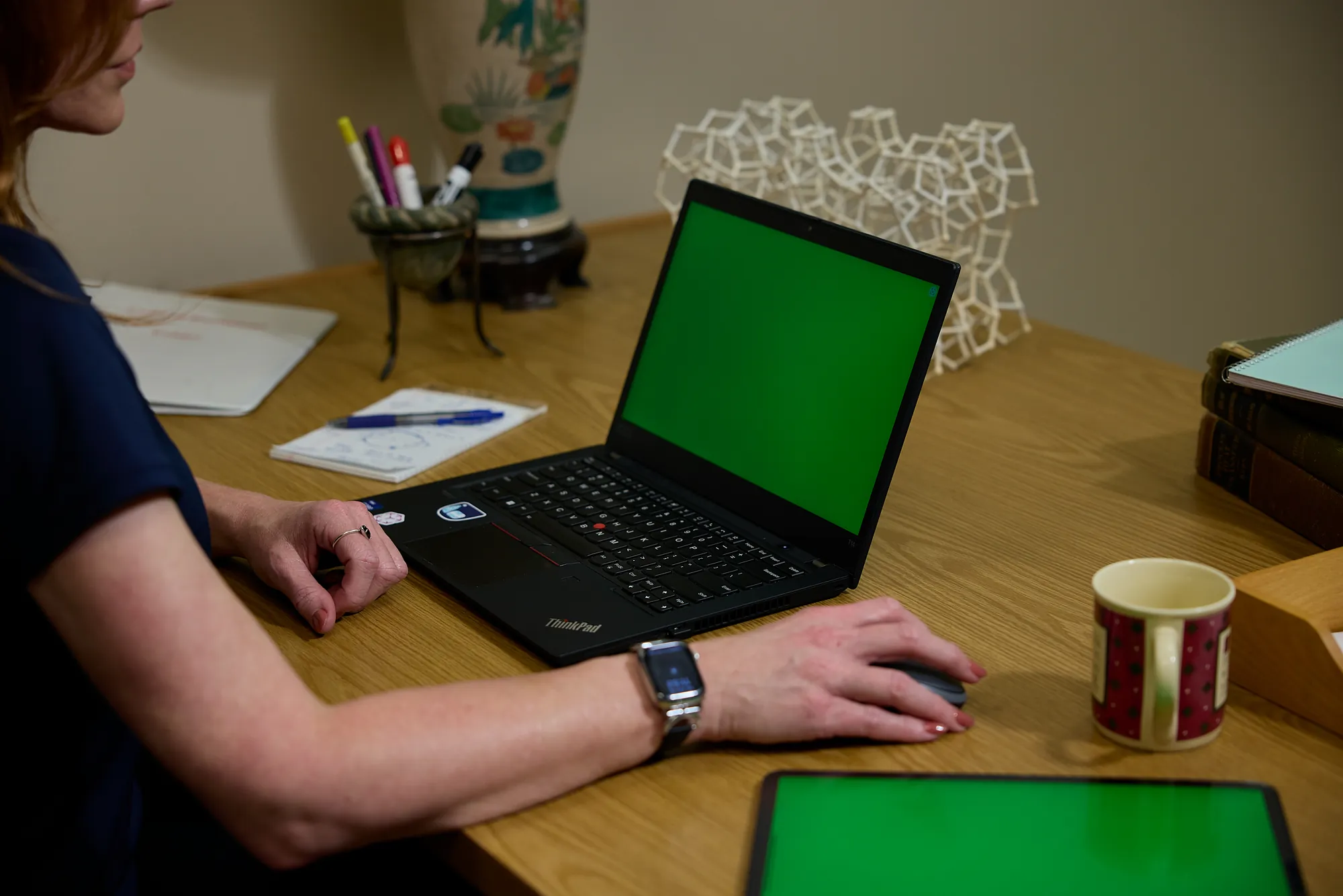 Engineer working on a laptop beside a tablet at a desk