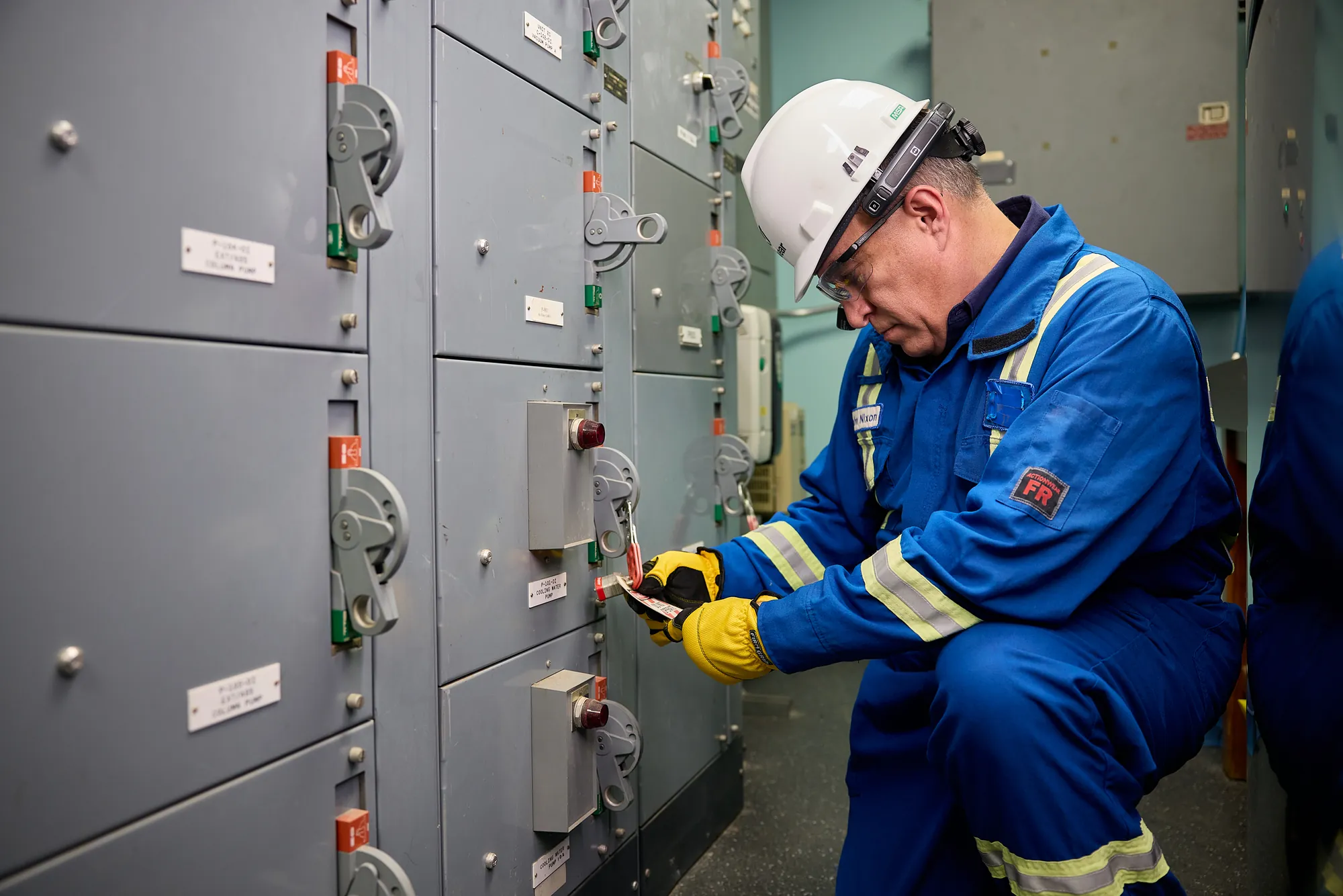 Technician working at an electrical panel
