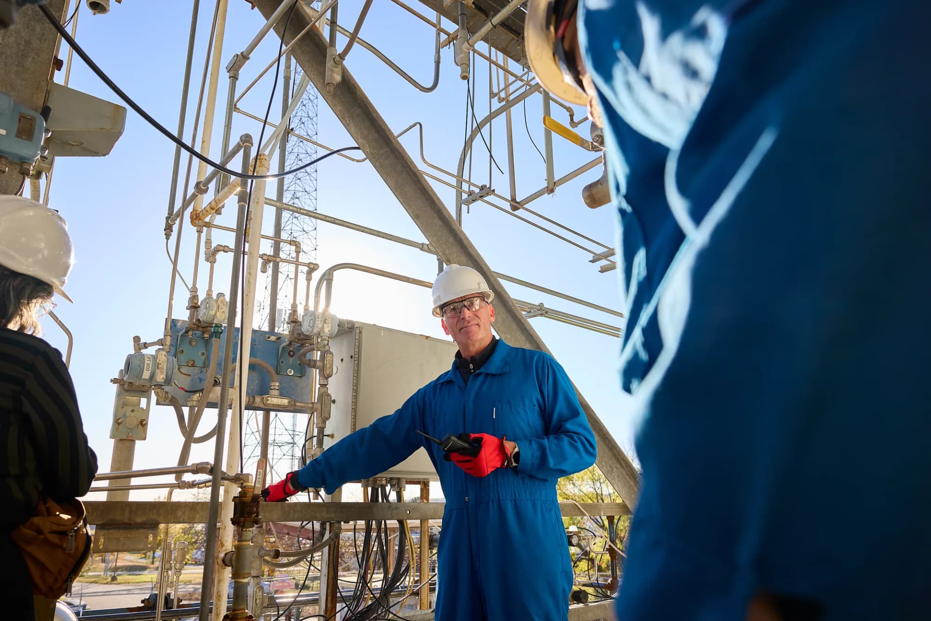 Worker in a hard hat on an elevated plant platform