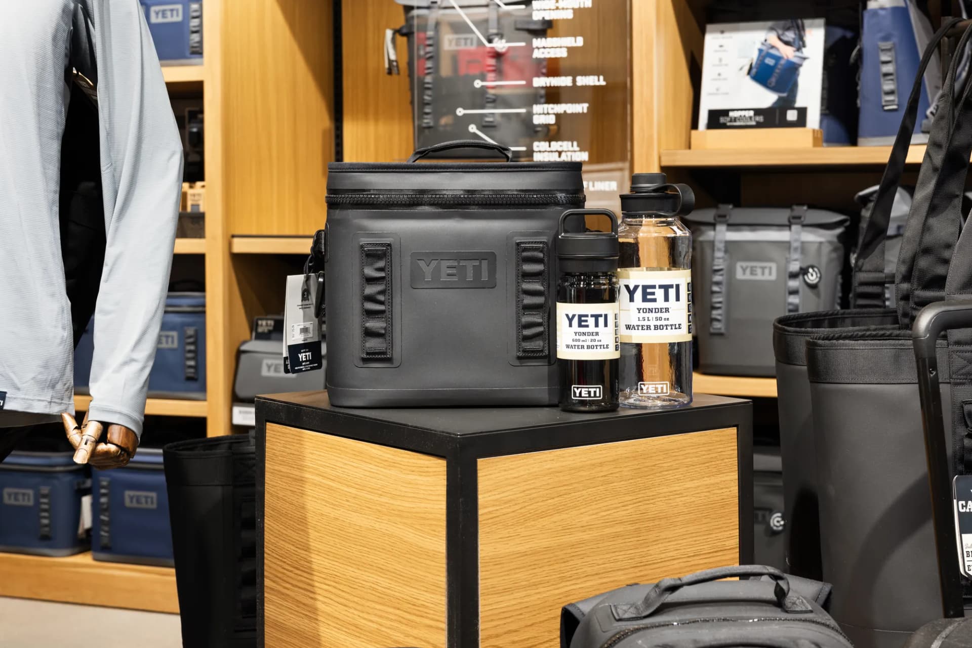 YETI soft coolers and bags on a wood display
