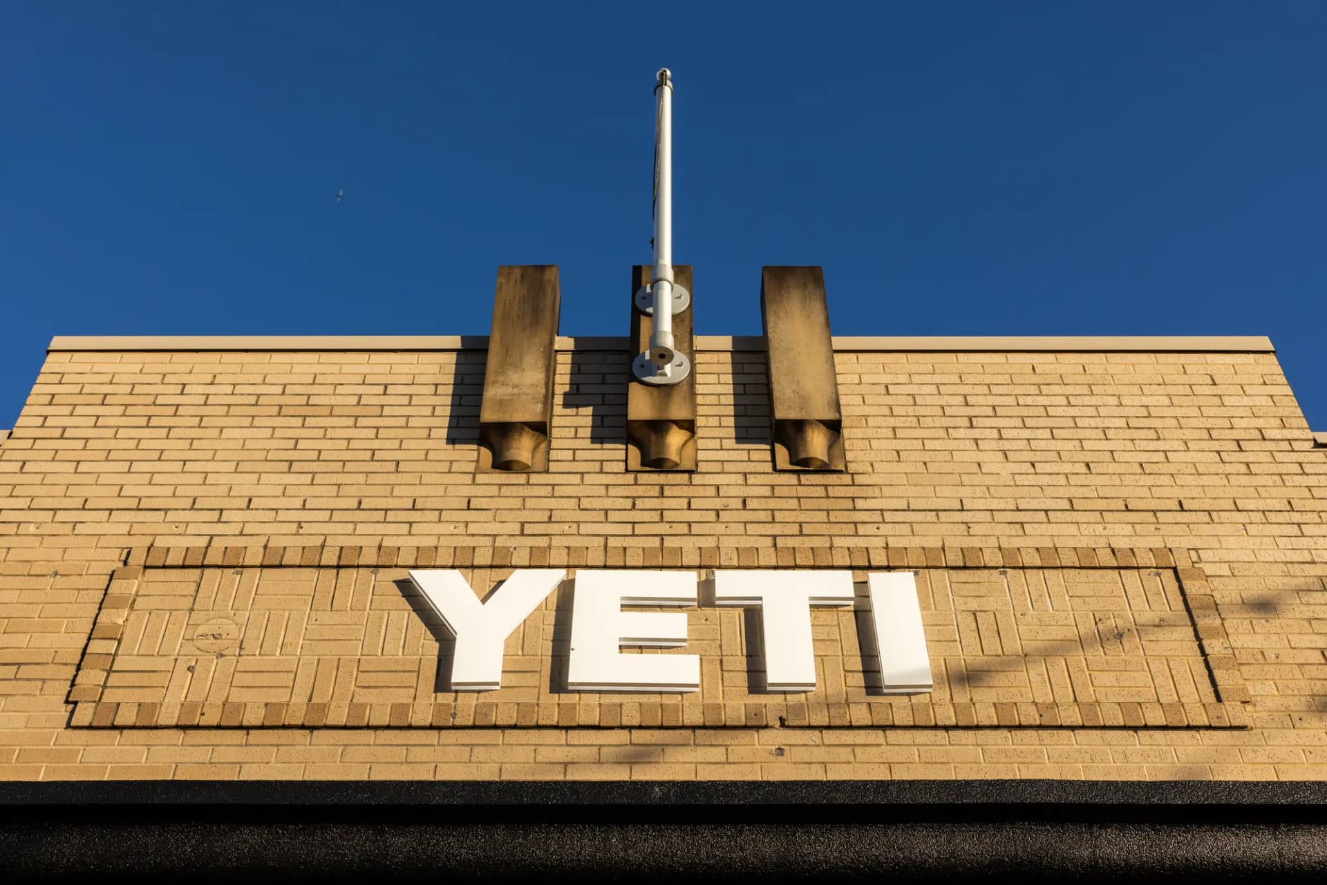 YETI lettering on the brick facade against a blue sky